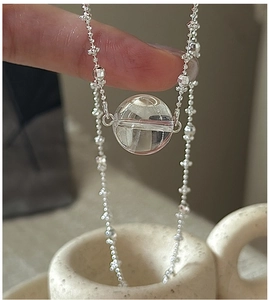 Close-up of S925 sterling silver chain featuring a clear white crystal ball pendant