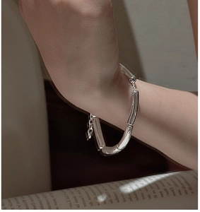 Close-up of minimalist S925 sterling silver bamboo link bracelet on woman's wrist