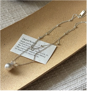 Detailed close-up of S925 sterling silver necklace with matte sphere and crystal pendant