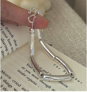 Macro detail of minimalist S925 silver hollow tube bracelet with elegant S-hook clasp