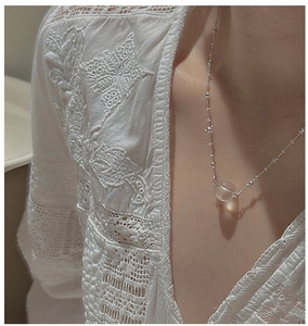 Detailed close-up of a S925 sterling silver necklace featuring a clear crystal bead pendant