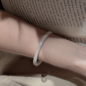 Elegant silver mesh textured open cuff bracelet for women shown on wrist