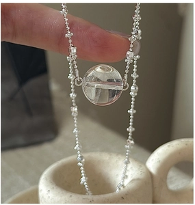 Detailed shot of S925 silver beaded chain necklace with clear round crystal pendant