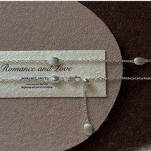 Macro detail of S925 sterling silver bean necklace with adjustable lobster clasp