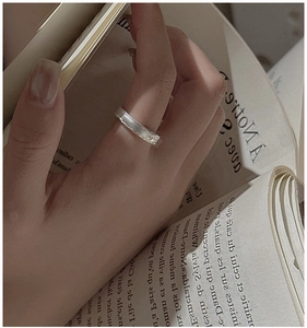 Close-up of S925 sterling silver ring featuring unique crumpled texture on wide band