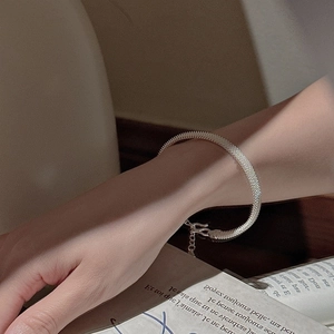 Elegant S925 sterling silver mesh bracelet on model hand with sophisticated woven texture