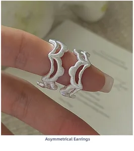 Close-up of S925 sterling silver earrings with wave design and brushed metal texture