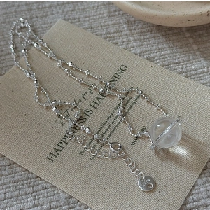 Detailed close-up of S925 sterling silver beaded chain with white crystal ball pendant