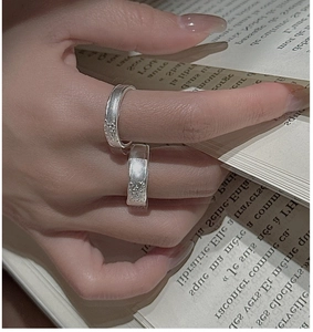 Close-up of S925 sterling silver rings with textured surface on a model's hand