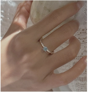 Detail of S925 silver ring with hammered texture and round blue aquamarine stone
