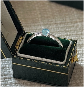 Macro detail of aquamarine silver ring with wave texture in a vintage velvet jewelry box