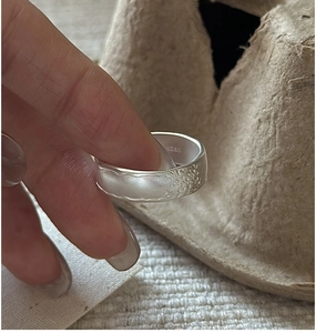 Macro view of S925 sterling silver ring showing matte wrinkled texture and S925 hallmark