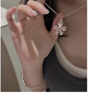 Detailed view of silver S925 hollow flower pendant on a sleek minimalist choker chain