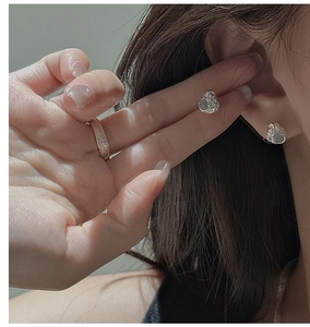 Detailed view of S925 sterling silver earrings and ring with irregular hammered texture