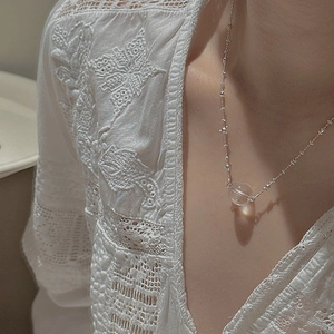 Elegant S925 sterling silver necklace with clear crystal pendant worn on collarbone