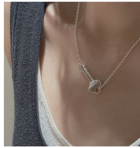 Detailed view of S925 sterling silver fine chain necklace with a vintage key pendant