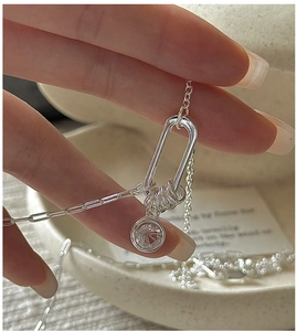Detail of S925 silver necklace with interlocking circles and a round cubic zirconia pendant