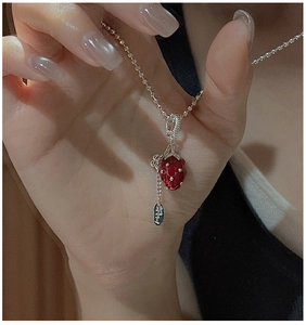 Macro detail of S925 silver strawberry pendant with realistic texture and beaded chain