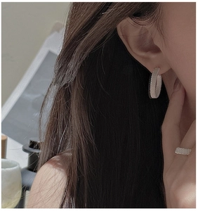 Detailed close-up of S925 sterling silver handmade woven wire hoop earrings and ring set
