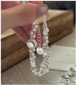 Detail of S925 sterling silver beaded bracelet with frosted disc charm and S925 tag