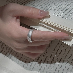 Minimalist S925 sterling silver ring with irregular lava texture worn on index finger