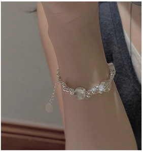 Close-up of S925 sterling silver beaded bracelet with flat charms and extension chain