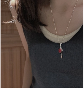 Macro detail of S925 sterling silver strawberry pendant with vintage red gemstone