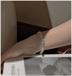 Detail of S925 sterling silver multilayer woven bracelet with silver beads and discs