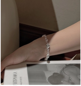 Close-up of S925 sterling silver multi-layer bracelet with round pendant on wrist