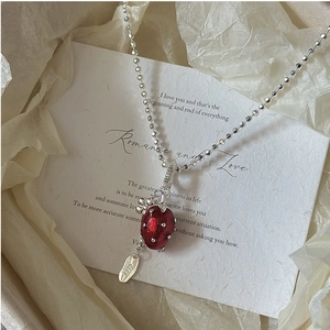 Close-up of S925 sterling silver strawberry pendant with polished red finish and hallmark