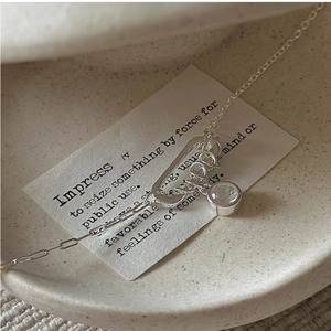 Macro shot of S925 silver link chain with D-ring clasp and clear crystal pendant detail