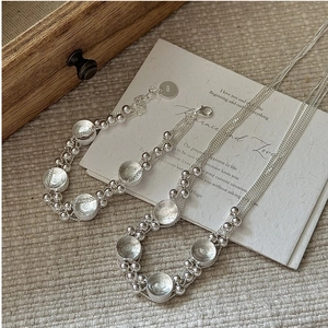 Detailed view of S925 sterling silver multilayer woven chain and round pendant charm