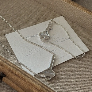 Set of two S925 sterling silver key bracelets featuring Love me engraving on linen