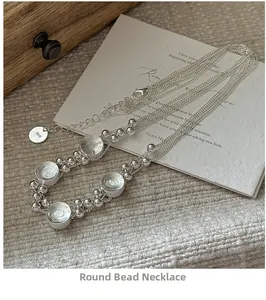 Detail of S925 sterling silver multi-layer beaded necklace on a vintage art card
