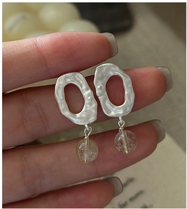 Macro detail of vintage S925 silver earrings with matte texture and crystal beads