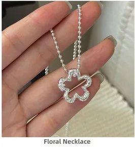 Macro shot of silver S925 floral pendant necklace with crystal details and bead chain
