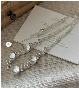 Detail of S925 sterling silver multi-layer necklace with lobster clasp and round charms