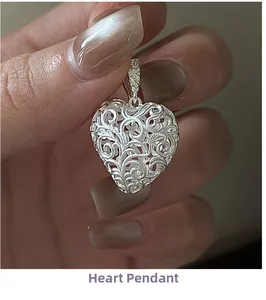 Macro shot of an S925 sterling silver heart pendant with vintage hollowed floral patterns