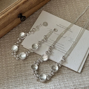Minimalist S925 sterling silver multi-layer necklace and bracelet set on artistic card