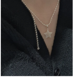 Detail of S925 sterling silver 3D mesh star pendant necklace on model collarbone