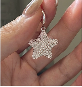 Macro shot of a 925 silver star pendant featuring a detailed 3D mesh texture and polished ring