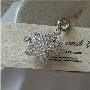 Macro shot of 3D mesh star pendant in S925 sterling silver with polished ring detail