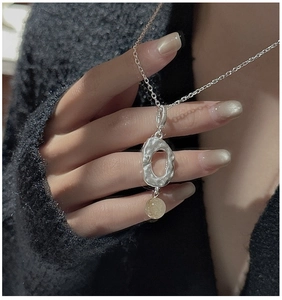 Detailed view of S925 silver necklace with irregular pendant and yellow crystal bead