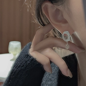 Minimalist S925 sterling silver oval earrings with matte texture on female model