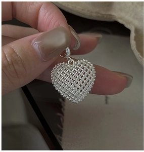 Detailed view of S925 sterling silver hollow 3D woven grid heart pendant with hanging loop