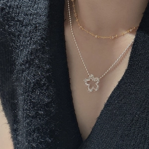 Dual-layer S925 silver necklace featuring a hollow flower pendant on a beaded chain