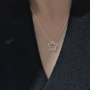 Minimalist S925 sterling silver necklace featuring a hollow five-petal flower pendant