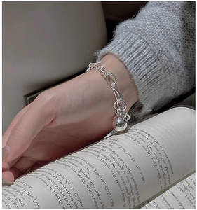 Close-up of S925 sterling silver beaded chain bracelet with a polished sphere charm