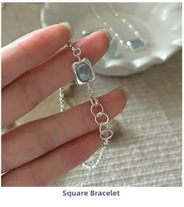 Detailed close-up of a S925 sterling silver beaded bracelet with a square blue gemstone