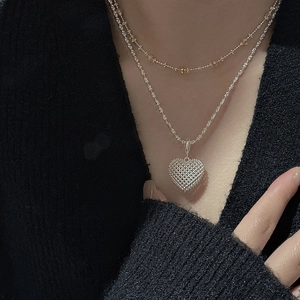 Layered S925 silver necklace featuring a 3D hollow mesh heart pendant on a model